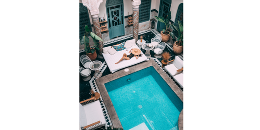 Homeowner comparing pool kits and custom pool builder options for an inground pool project