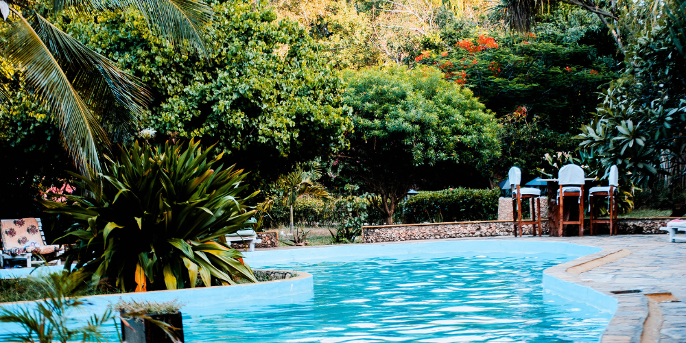 Inground pool installation process in a residential backyard during early construction stages