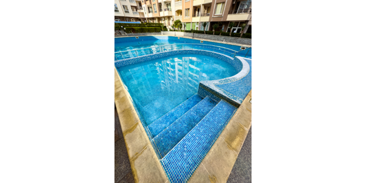 Homeowner comparing pool kits and custom pool builder options for an inground pool project