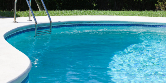 Pool owner performing simple daily pool maintenance tasks in a residential backyard